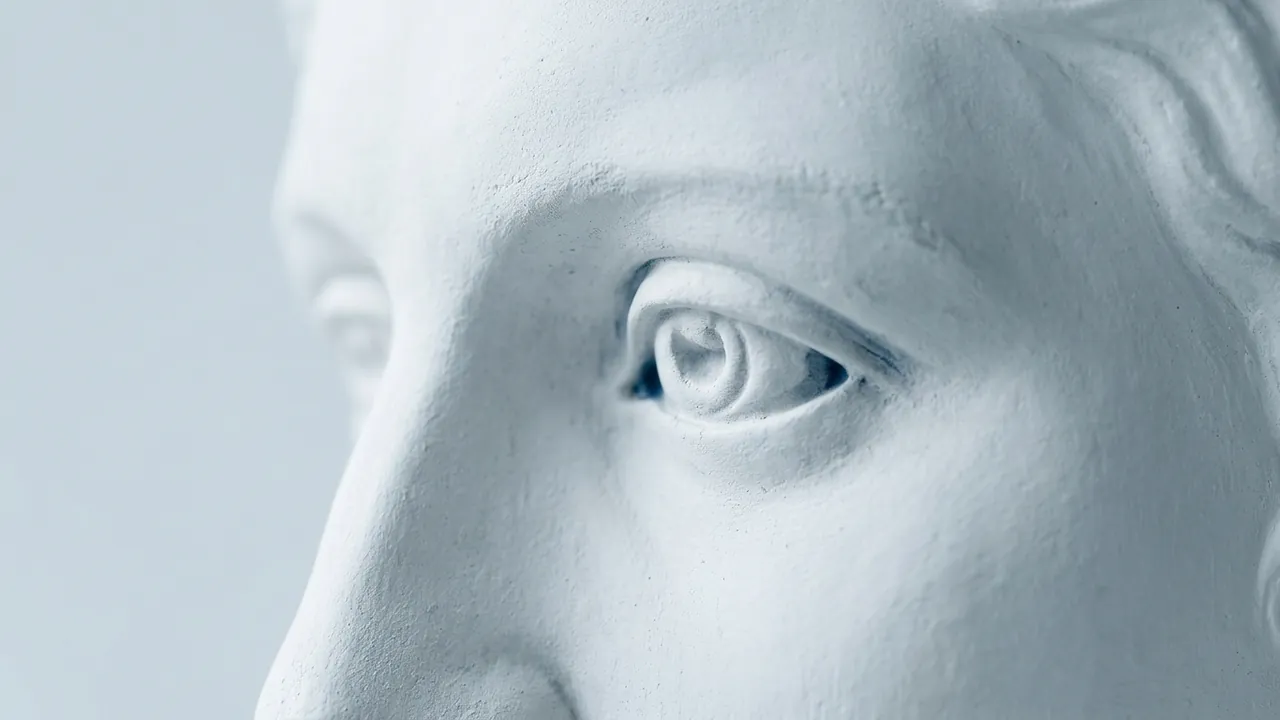 Extreme close-up of a white plaster statue's carved eye and temple, the outer corner in sharp focus — fox eye surgery guide
